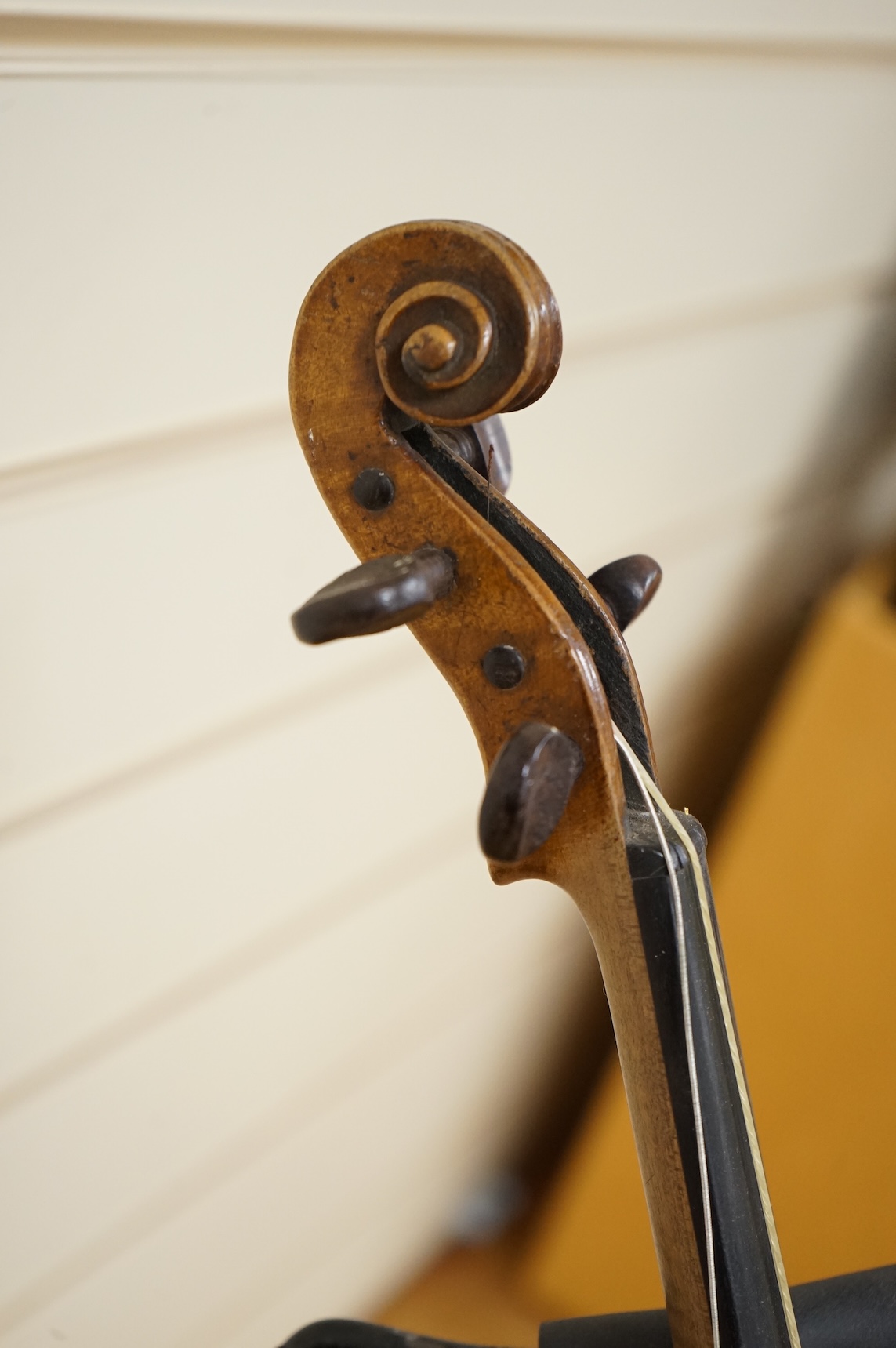 Five cased 20th century violins, including; a German violin, two Czech violins, a three-quarter size violin with a label for Bienfait, and a Romanian quarter size violin, all in cases or the remains of cases.